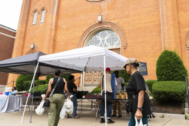 Shoppers at Farmers Market on Porter Avenue in front of Holy Angels Church